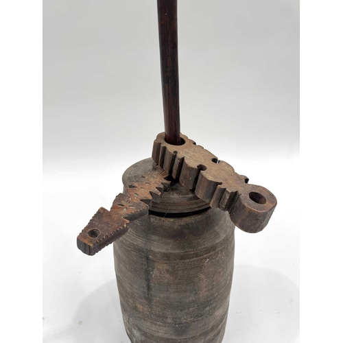 260 - A Nepalese turned hardwood butter churn with lid, dash/plunger terminating in a cross-form paddle, a... 