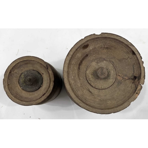 262 - Two Nepalese turned hardwood lidded vessels, cylindrical body with flared rims, designed for the fer... 