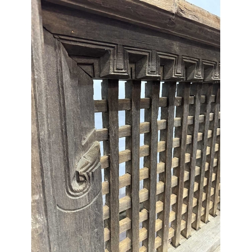 263 - A 19th century or earlier Nepalese wooden window, dentil carving above open lattice grill, Kathmandu... 