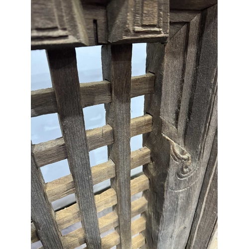 263 - A 19th century or earlier Nepalese wooden window, dentil carving above open lattice grill, Kathmandu... 