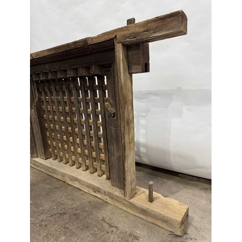 263 - A 19th century or earlier Nepalese wooden window, dentil carving above open lattice grill, Kathmandu... 