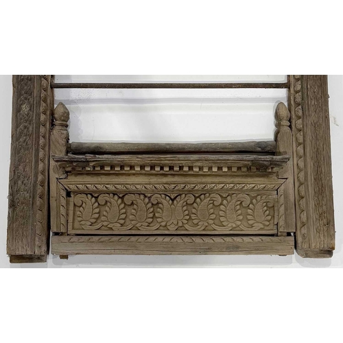 266 - A richly carved Nepalese window frame, 19th century or earlier, salvaged from a noble house or palac... 