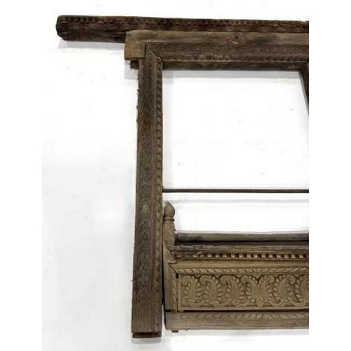 266 - A richly carved Nepalese window frame, 19th century or earlier, salvaged from a noble house or palac... 