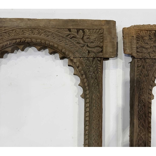 267 - A pair of richly carved Nepalese sectional window frames, 19th century or earlier, salvaged from a n... 