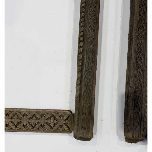 267 - A pair of richly carved Nepalese sectional window frames, 19th century or earlier, salvaged from a n... 
