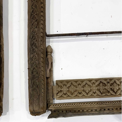 267 - A pair of richly carved Nepalese sectional window frames, 19th century or earlier, salvaged from a n... 