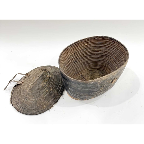 276 - A 19th century Nepalese dowry box and lid, leather over a cane structure, iron fastenings, h:48, w:5... 