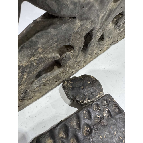 287 - A carved wood panel depicting a figure on horseback amongst a scrolling floriate background, tarred ... 