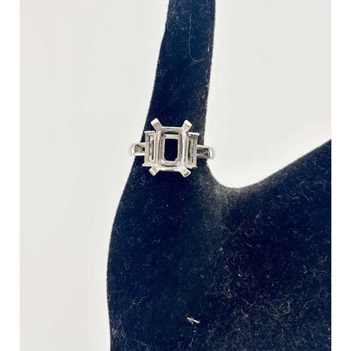 415 - A platinum ring mount, designed for a central rectangular-shape stone flanked by baguette settings a... 