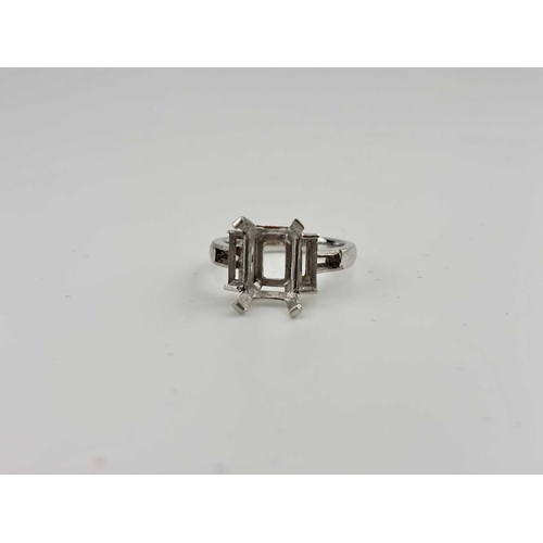 415 - A platinum ring mount, designed for a central rectangular-shape stone flanked by baguette settings a... 