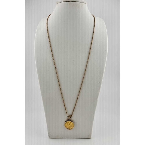 438 - A 9ct gold mounted half sovereign pendant, with chain, pendant mount with hallmarks for London 1962,... 