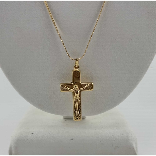 439 - A crucifix pendant, with serpentine-link chain, both stamped 750, length of pendant 3.6cm, length of... 