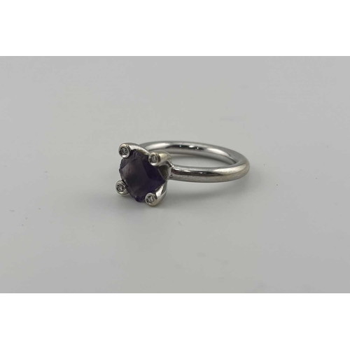 454 - An amethyst and diamond ring, stamped 750, ring size N, amethyst AF, 7.9g