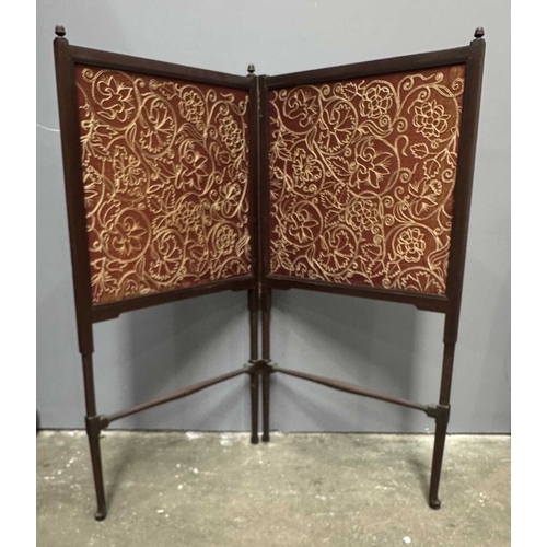 478 - An Arts and Crafts circa 1900, walnut and silk embroidered fire screen with two panels on slender tu... 