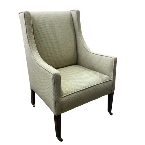 541 - An early 20th century square wingback armchair or easy chair, with sloping arms, on mahogany legs to... 