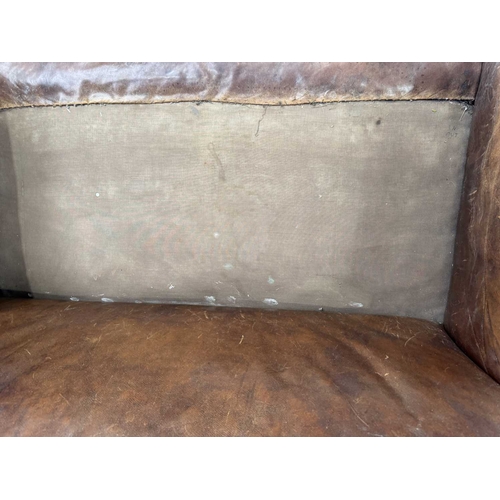 542 - An art deco brown leather three piece suite, low slung and deep seated, lyre shaped arms, with brass... 