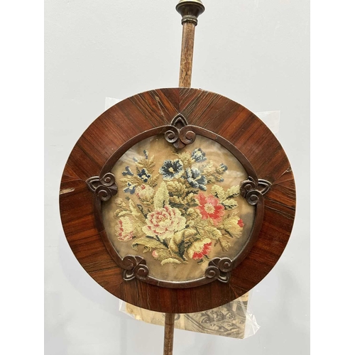 543 - A regency rosewood pole screen, tri-form base on winged feet, rising to a reeded baluster to a taper... 