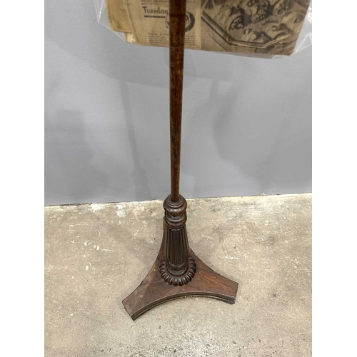 543 - A regency rosewood pole screen, tri-form base on winged feet, rising to a reeded baluster to a taper... 