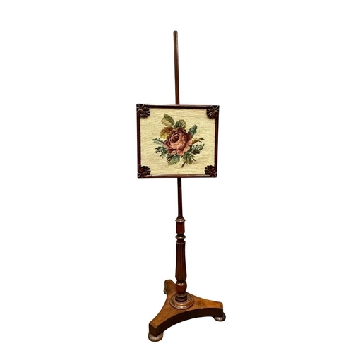 544 - A Regency mahogany pole screen with tapestry panel, triform platform base to a reeded column up to a... 