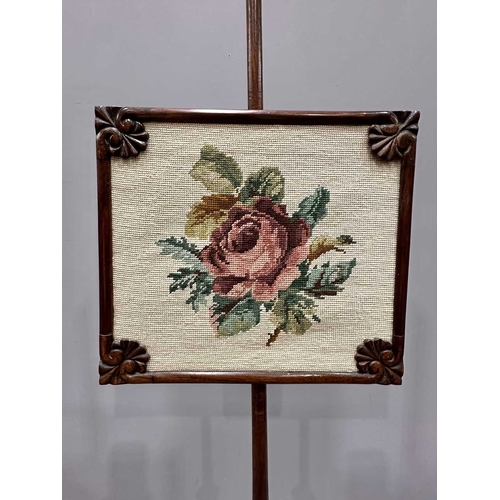 544 - A Regency mahogany pole screen with tapestry panel, triform platform base to a reeded column up to a... 