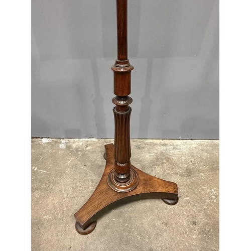 544 - A Regency mahogany pole screen with tapestry panel, triform platform base to a reeded column up to a... 