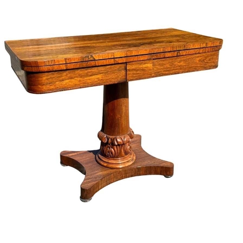 545 - A mid 19th century rosewood foldover games table, central column sitting on acanthus carved support,... 