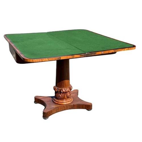 545 - A mid 19th century rosewood foldover games table, central column sitting on acanthus carved support,... 