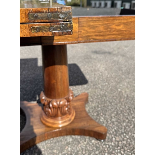 545 - A mid 19th century rosewood foldover games table, central column sitting on acanthus carved support,... 