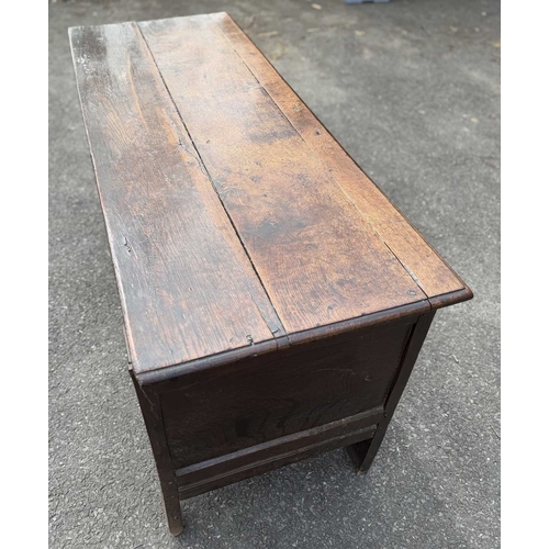 548 - An 18th century panelled, oak coffer or chest with floral and foliate carvings to the three front pa... 