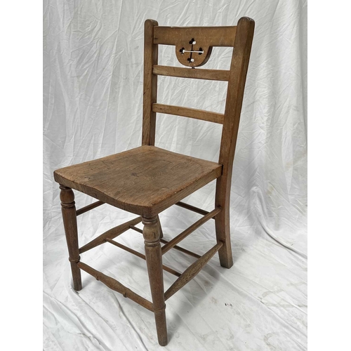 549A - A pair of beech and elm chairs, 19th century, possibly from a church, the top rails carved with cros... 