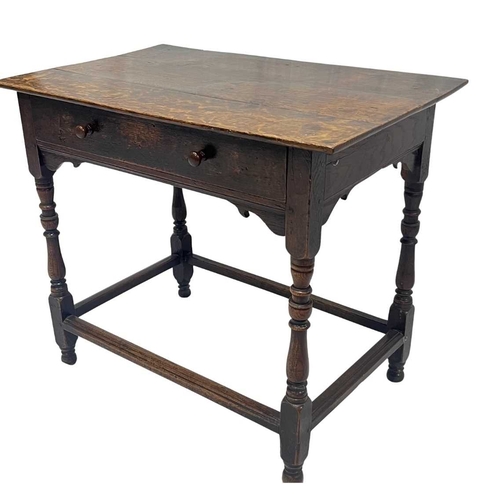 551 - An 18th century oak side table, 2 plank top, above a drawer with round knobs, turned legs united by ... 