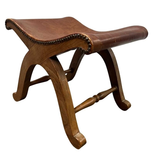 552 - A Spanish wood and leather x-frame stool, 20th century, Probably by Pierre Lottier for Valmazan, uph... 