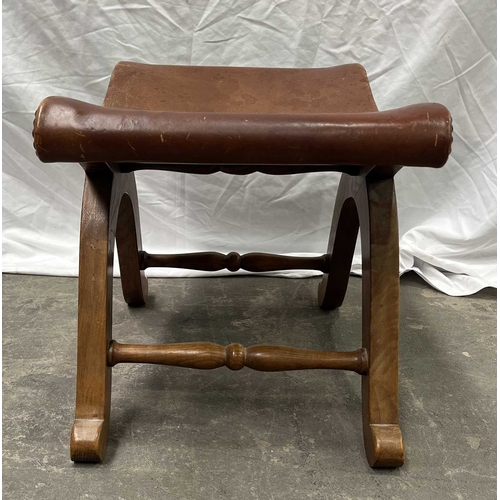 552 - A Spanish wood and leather x-frame stool, 20th century, Probably by Pierre Lottier for Valmazan, uph... 