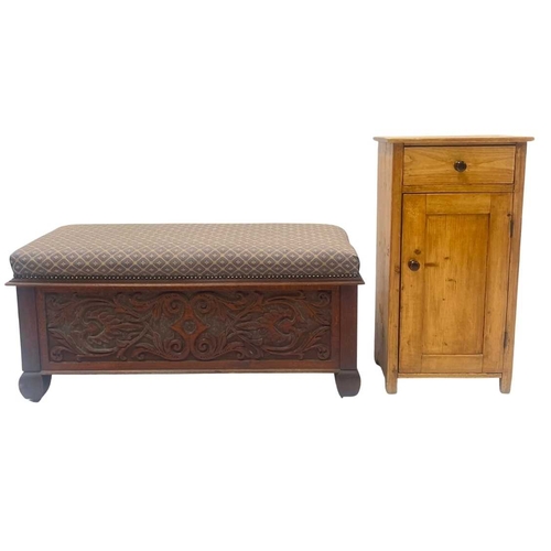 553 - An oak ottoman or blanket box, over stuffed padded top, opening to storage, heavily carved panels to... 