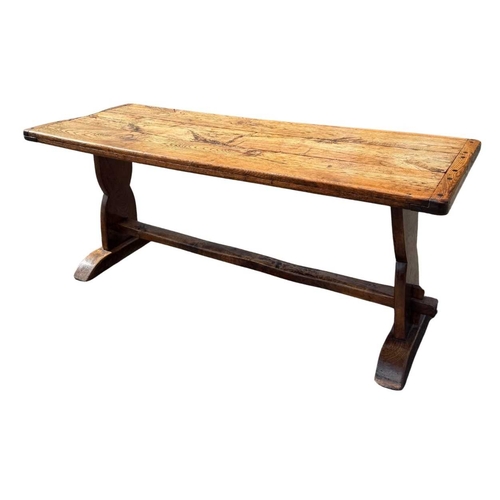 554 - A cleated elm plank top refectory table, 19th century or earlier, trestle support with central stret... 