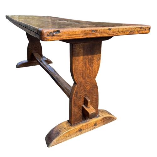 554 - A cleated elm plank top refectory table, 19th century or earlier, trestle support with central stret... 