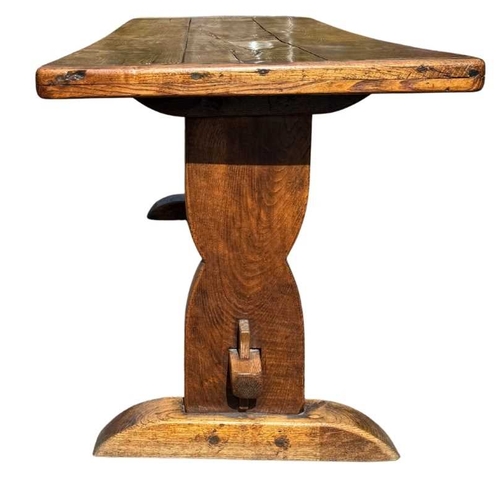 554 - A cleated elm plank top refectory table, 19th century or earlier, trestle support with central stret... 