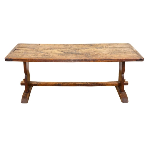 554 - A cleated elm plank top refectory table, 19th century or earlier, trestle support with central stret... 