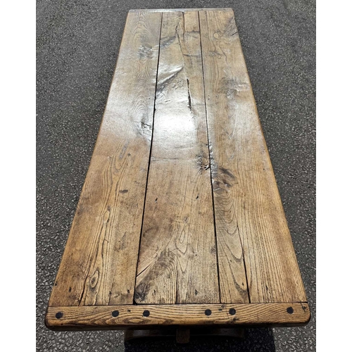 554 - A cleated elm plank top refectory table, 19th century or earlier, trestle support with central stret... 