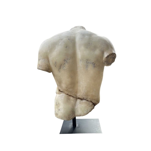 556 - A marble dust resin torso of a male nude after the 'Discophorus' / 'Discophoros' torso from antiquit... 