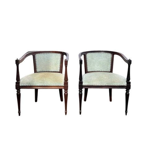 564 - A pair of early 20th century rosewood tub chairs, open sided, padded central back, on slim tapering ... 