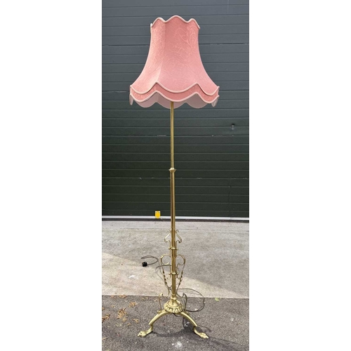 566 - A pair of brass standard lamps in the art nouveau style, telescopic columns down to strapwork and wr... 