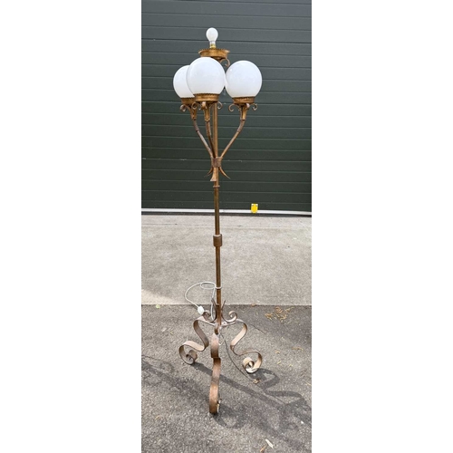 567 - A gilded wrought metal 4-light standard lamp, central column with light supported by scrolls above t... 