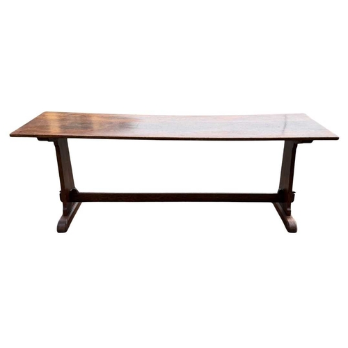 571 - An oak refectory or dining table, three plank top, supported at either end by splats fixed with pegs... 