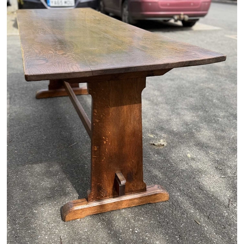 571 - An oak refectory or dining table, three plank top, supported at either end by splats fixed with pegs... 