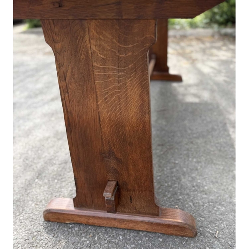 571 - An oak refectory or dining table, three plank top, supported at either end by splats fixed with pegs... 
