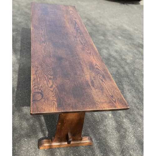 571 - An oak refectory or dining table, three plank top, supported at either end by splats fixed with pegs... 