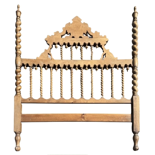 573A - A Spanish or Portuguese wooden bed headboard, barley twist newel posts surmounted by urn finials, ce... 
