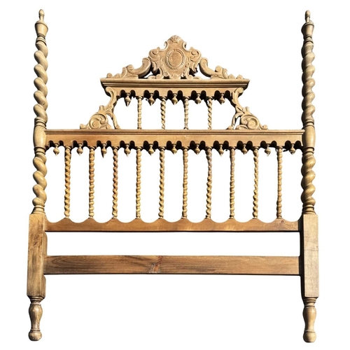573A - A Spanish or Portuguese wooden bed headboard, barley twist newel posts surmounted by urn finials, ce... 