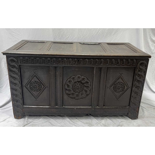 579 - An 18th century or earlier oak coffer, four panel top opening to storage, three carved panel front, ... 